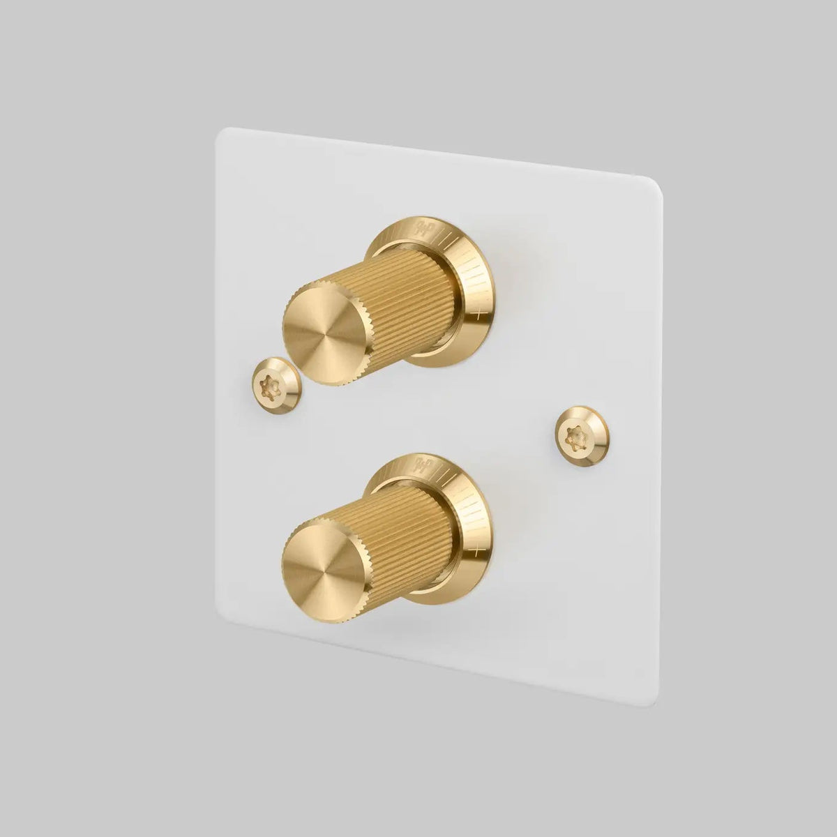 Buster and Punch two gang two way dimmer light switch in white with brass linear knurled knobs