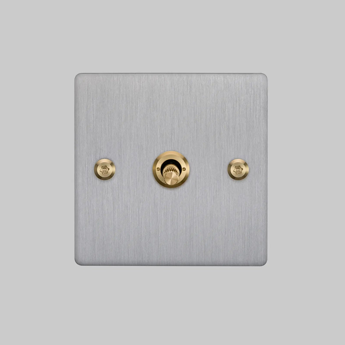Buster and Punch steel one gang two way light switch with brass linear knurled toggle