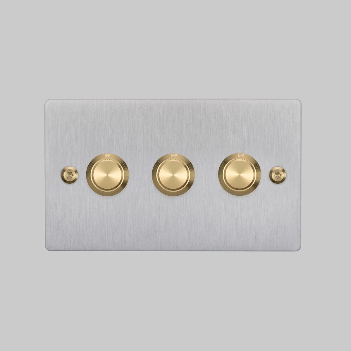 Buster and Punch three gang steel dimmer switch with brass linear knurled knobs