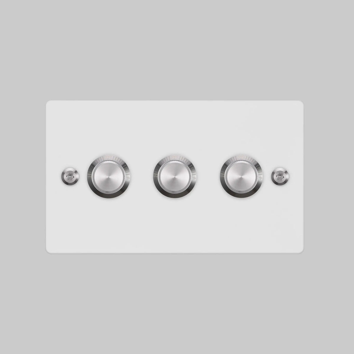 White triple rotary dimmer switch with silver knobs on a rectangular plate