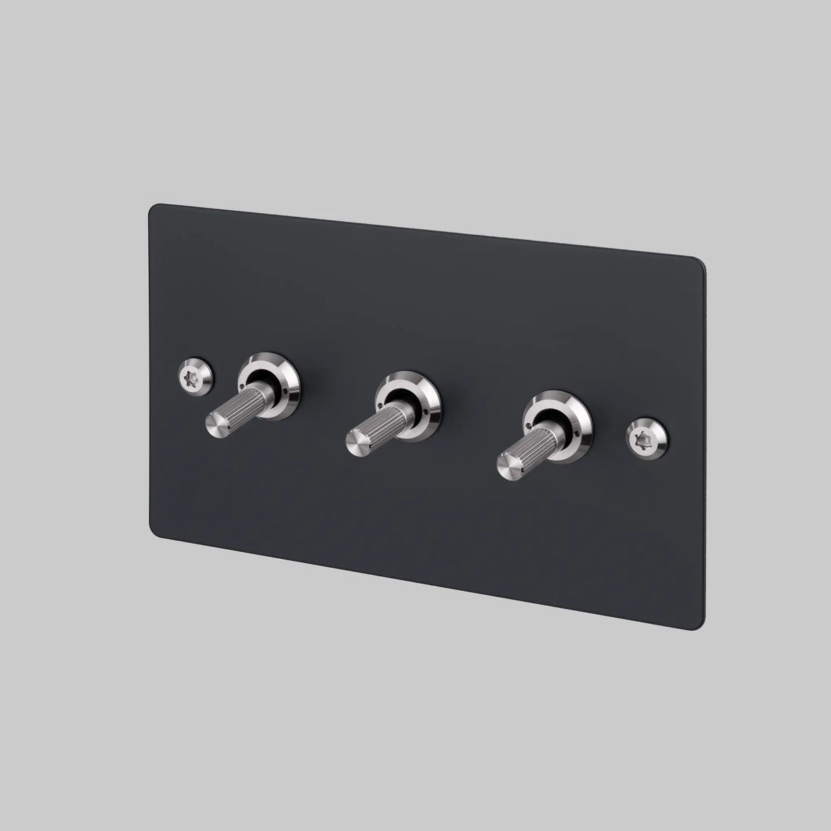 Triple toggle light switch with matte black rectangular plate and silver metal textured levers