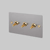 Three Gang 2 Way Light Switch in Steel with Brass Linear Knurled Toggles