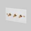 Three Gang 2 Way Light Switch in White with Brass Linear Knurled Toggles