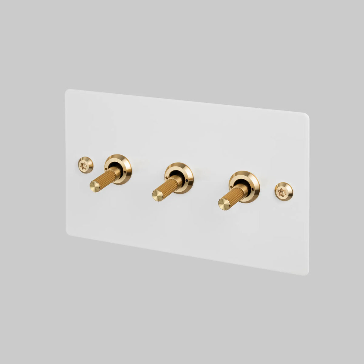 Three Gang 2 Way Light Switch in White with Brass Linear Knurled Toggles
