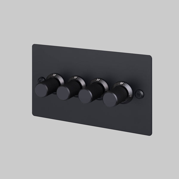 Four black dimmer switches on a black rectangular plate
