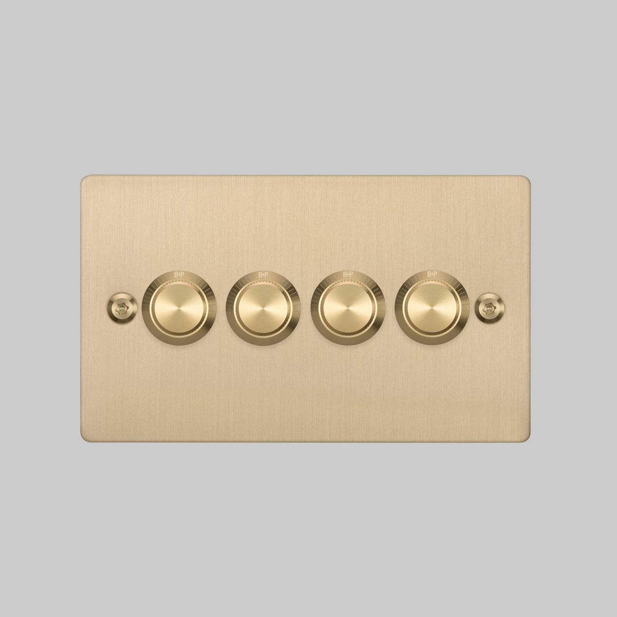 Four-gang dimmer switch in brushed brass with B+P branding
