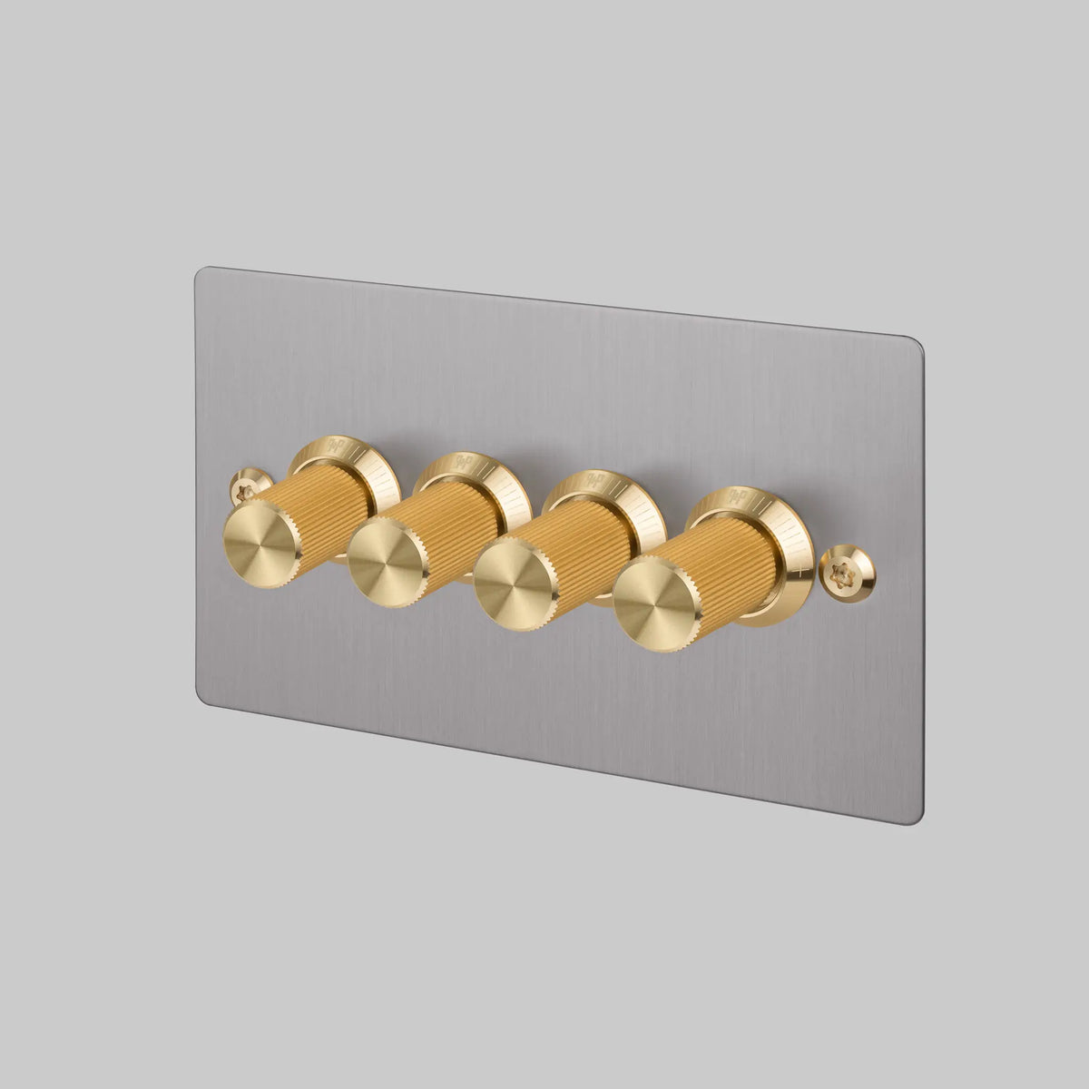 Buster and Punch four gang two way dimmer light switch in steel with brass linear knurled knobs