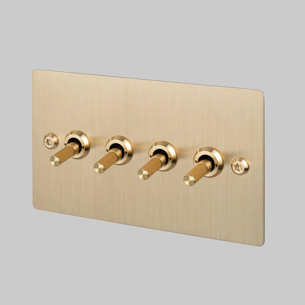 Four Gang 2 Way Light Switch in Brass with Linear Knurled Toggles
