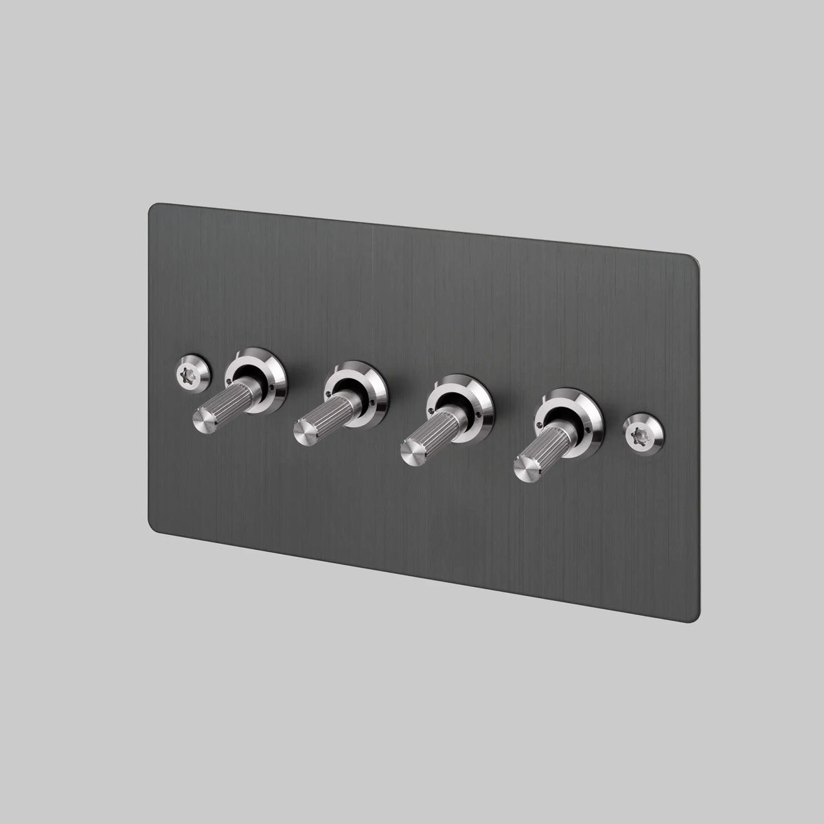 Buster and Punch four gang two way light switch in smoked steel with brass linear knurled toggles