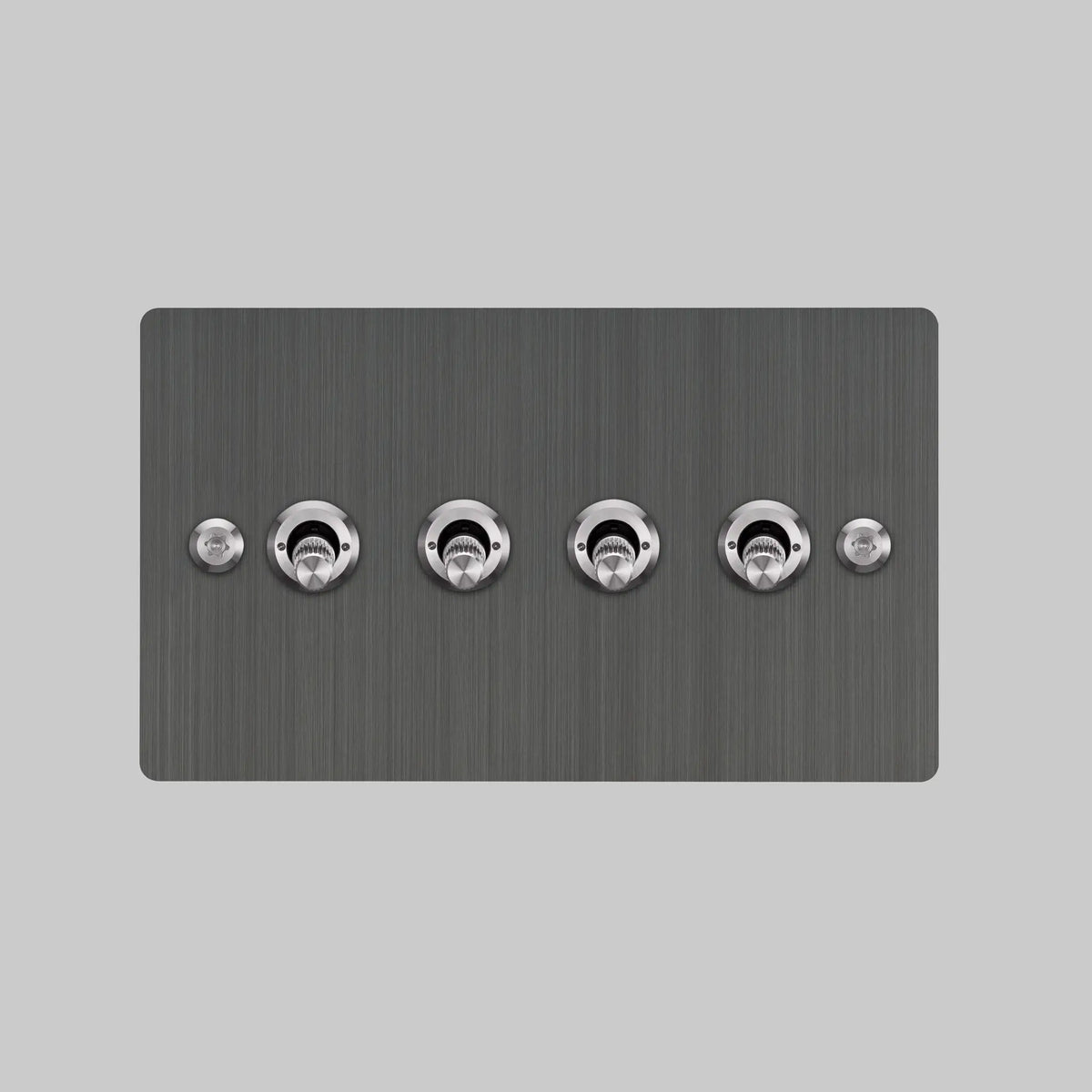 Buster and Punch four gang two way light switch in smoked steel with brass linear knurled toggles