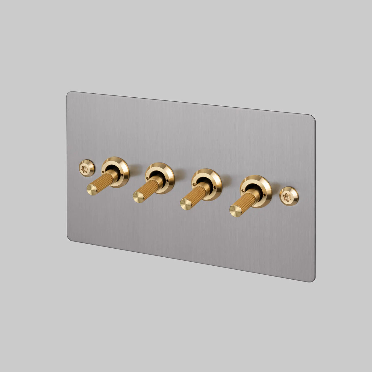 Buster and Punch four gang two way steel light switch with brass linear knurled toggles