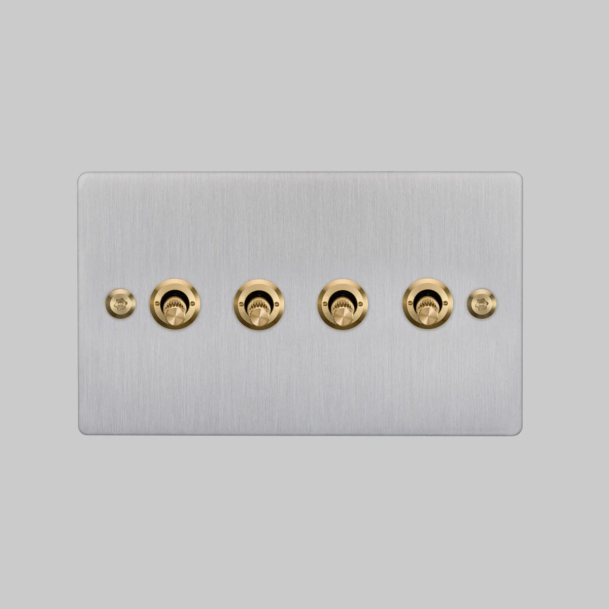Buster and Punch four gang two way light switch in steel with brass linear knurled toggles