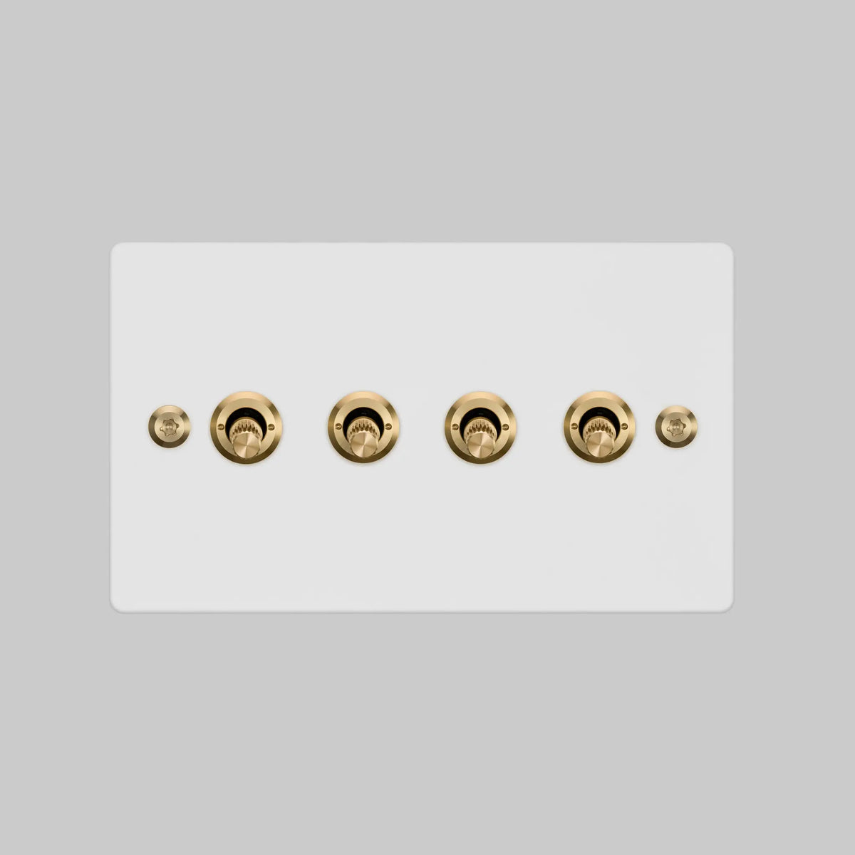 Four Gang 2 Way Light Switch in White with Brass Linear Knurled Toggles