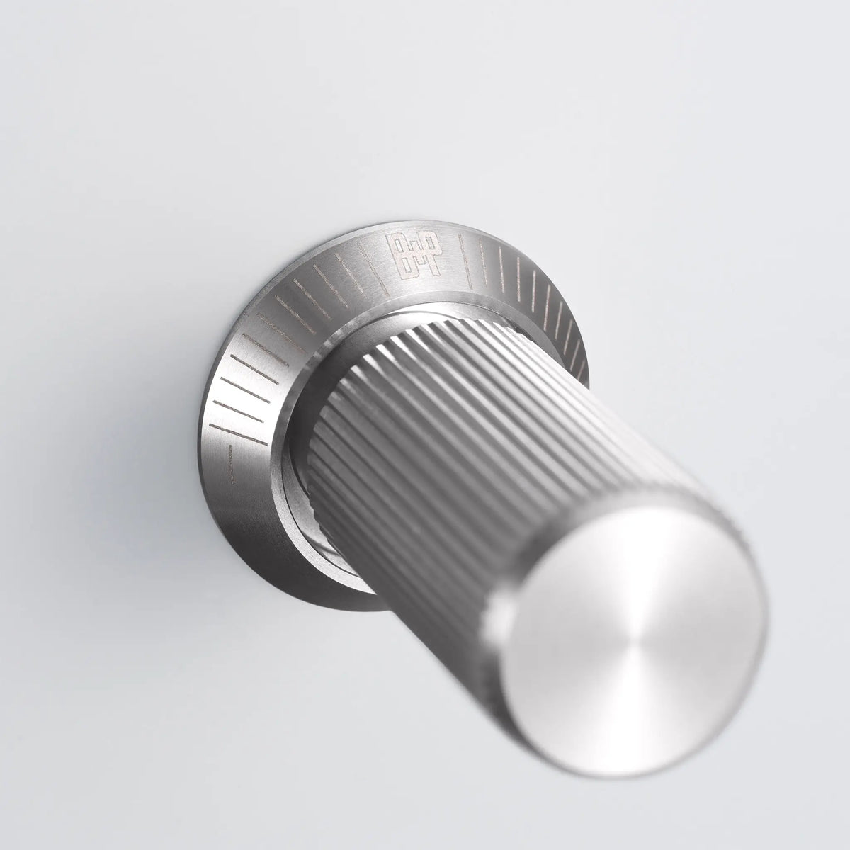 Buster and Punch steel linear knurled dimmer knob on white switch plate