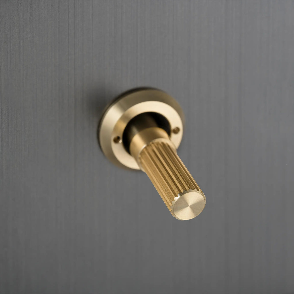 Buster and Punch smoked bronze light switch with brass linear knurled toggle