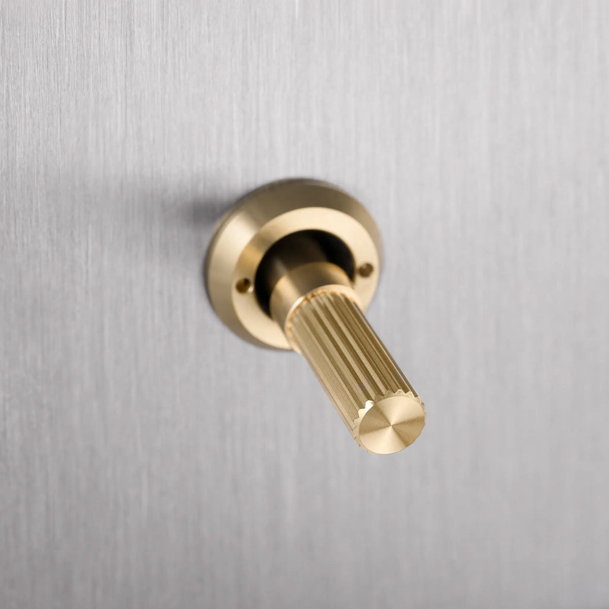 Buster and Punch steel light switch with brass linear knurled toggle