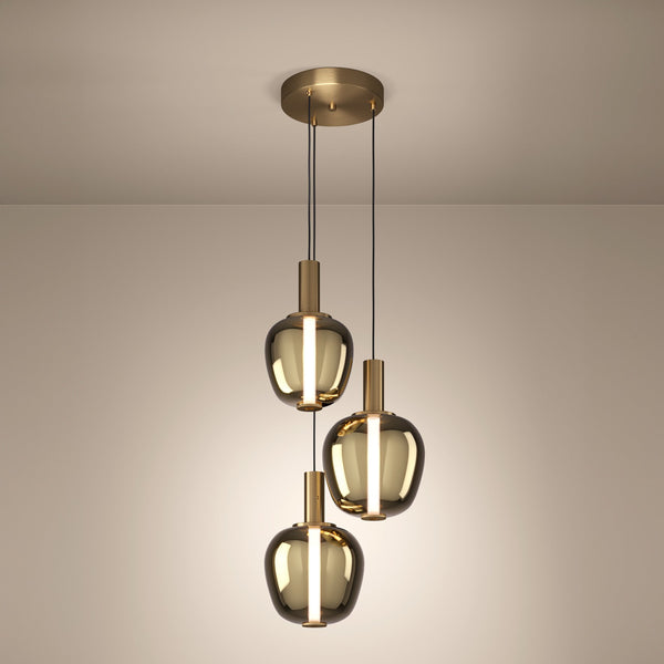 Three modern pendant lights with smoked glass shades and brass accents hang from a ceiling.