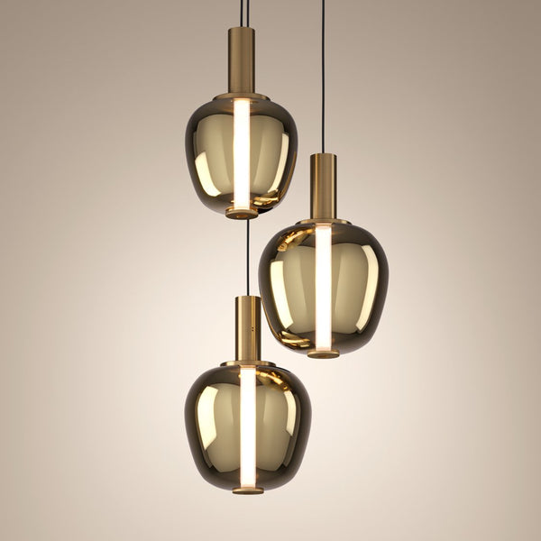 Three modern pendant lights with smoked glass shades and brass accents hang from the ceiling.