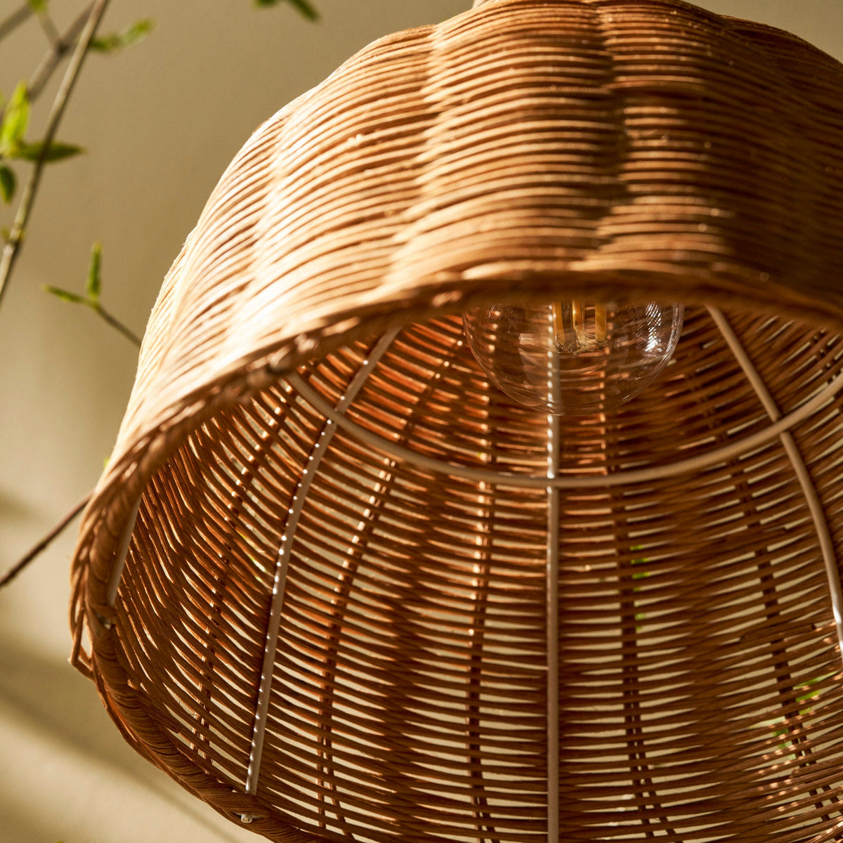 Interior view of the Mouldon Small Pendant in Rattan by Garden Trading Lighting showing the wire frame