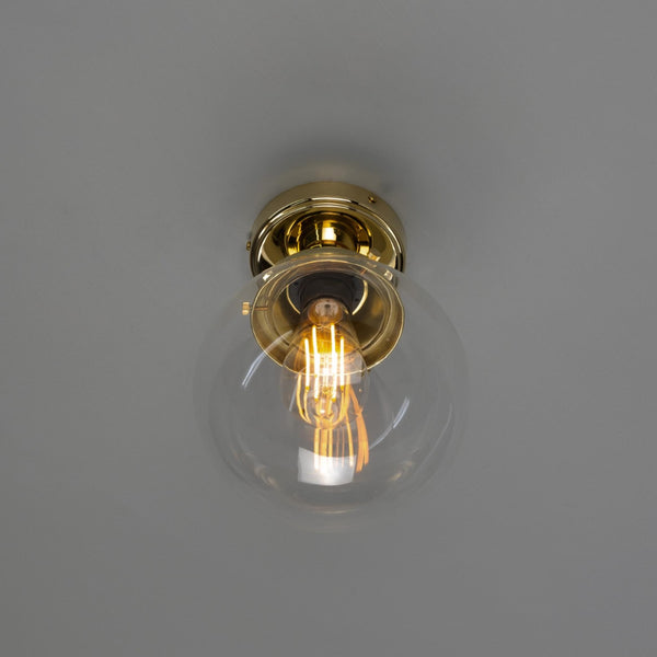 Mullan Deniz 20cm IP44 globe ceiling light in polished brass with a clear glass shade and exposed filament bulb
