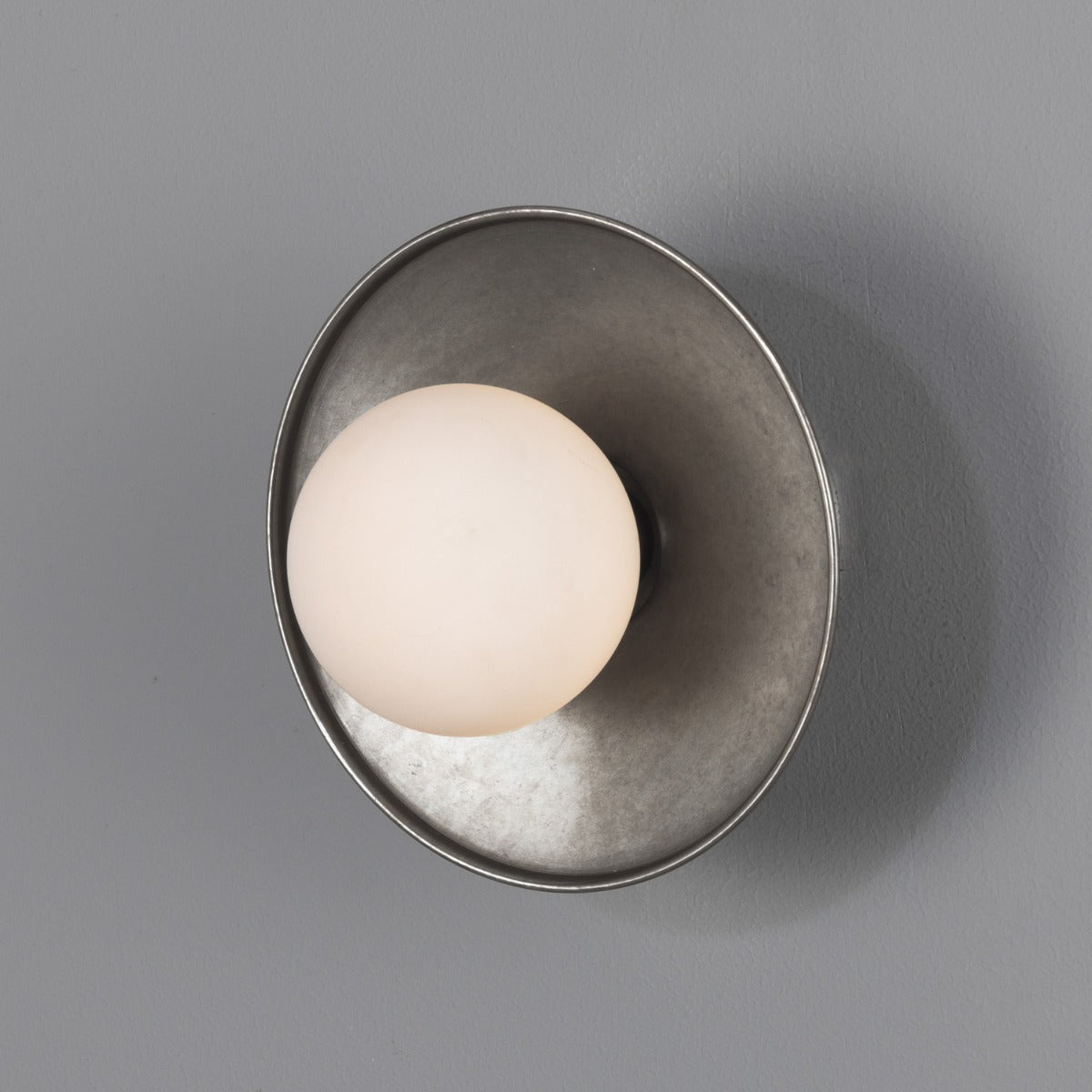 Aosta IP65 Brass Disc Bathroom Wall Light in Antique Silver with Opal Glass Globe