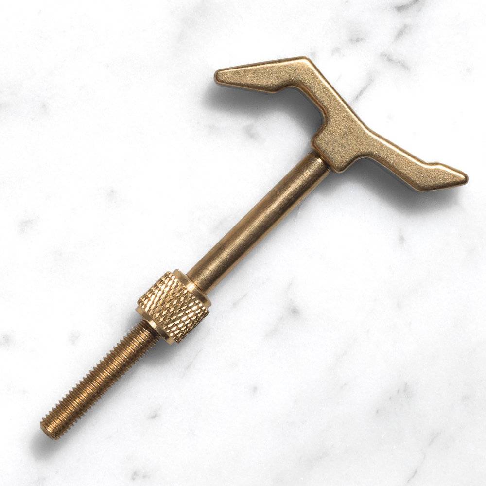 Brass watch tool with a T-shaped handle and a threaded screw end