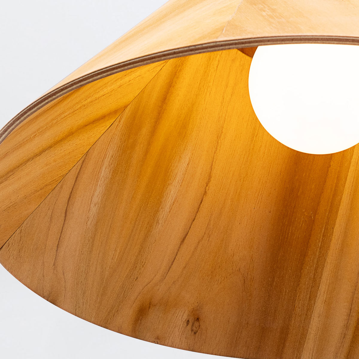 Accord Conical Natural Teak Wood Veneer Single Drop Pendant with a glowing bulb