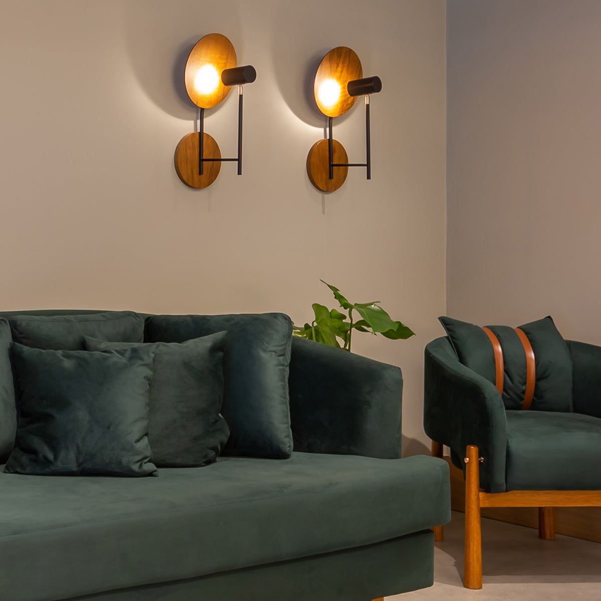 Two Accord Dot Natural Teak Wood Veneer Wall Lights above a green sofa and armchair