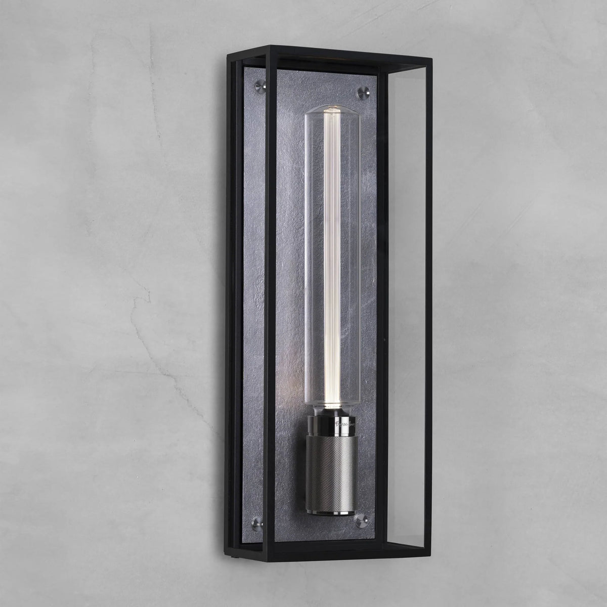 Black rectangular wall sconce with a clear cylindrical bulb on a textured grey wall