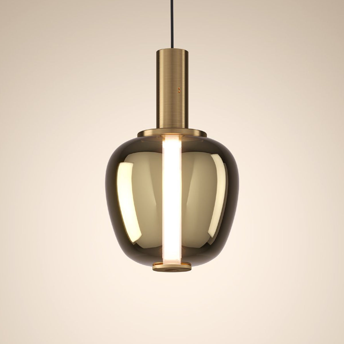 Modern pendant light with a brass cylindrical top and a smoked glass bell-shaped shade, emitting a warm glow.