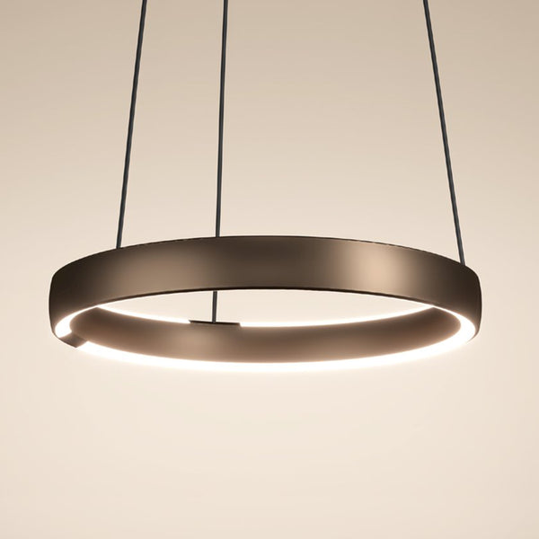 Modern circular pendant light with a dark bronze finish and illuminated inner ring.